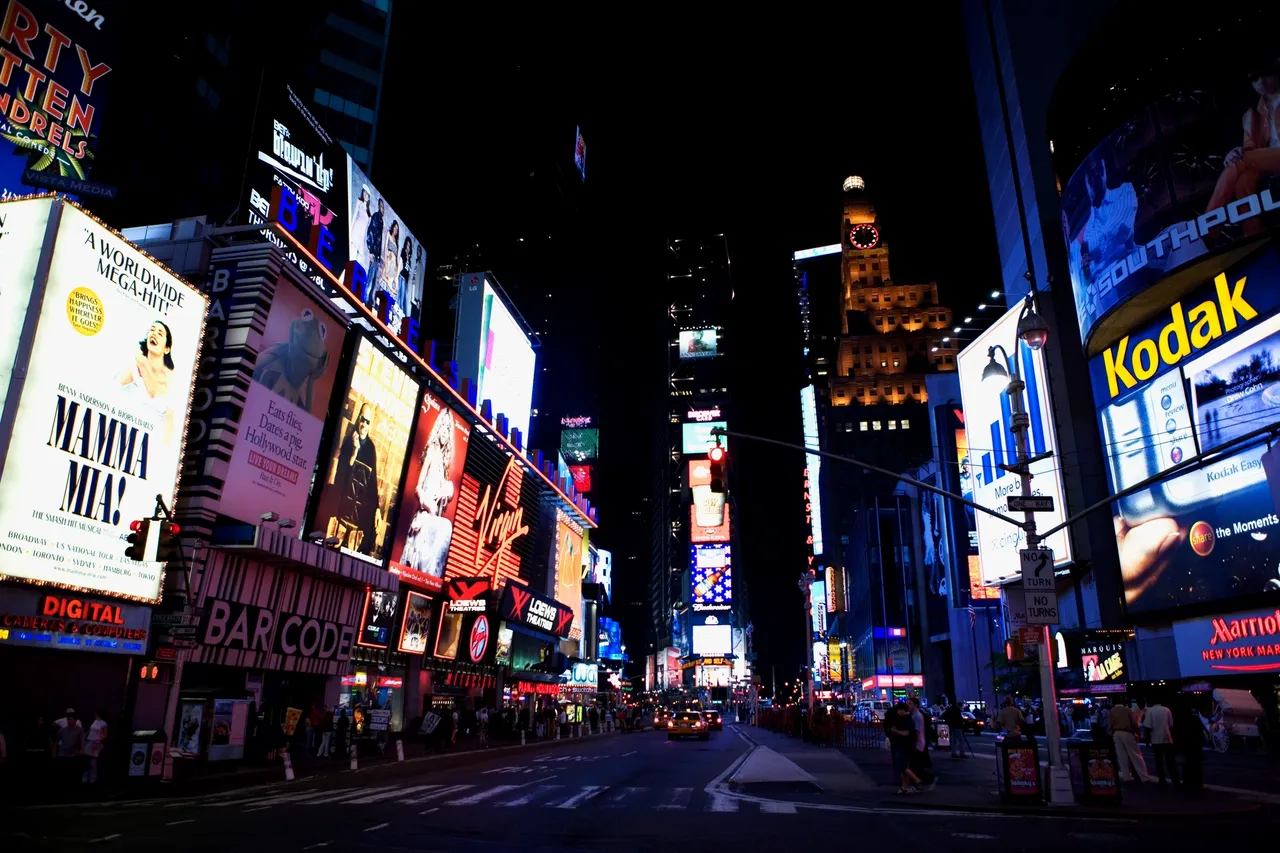 Times Square at night with bright neon lights and billboards.
