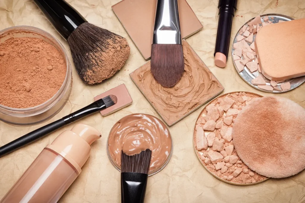 Various makeup brushes and powder foundations arranged closely.
