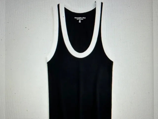 Black tank top with white trim around the neckline and armholes.
