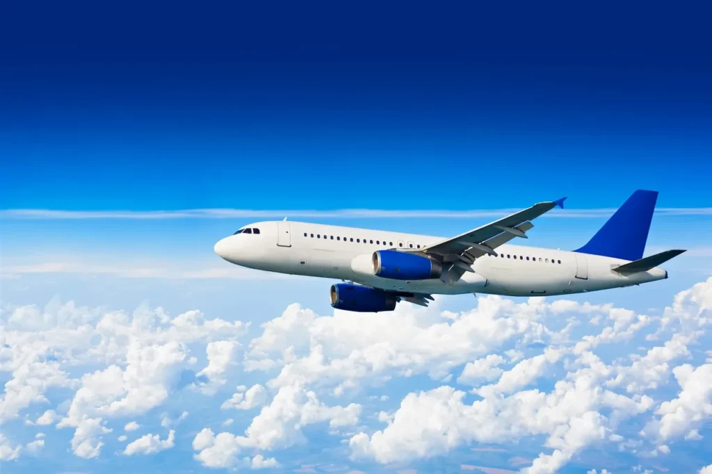 Woman in red dress holding a coffee cup and handbag.